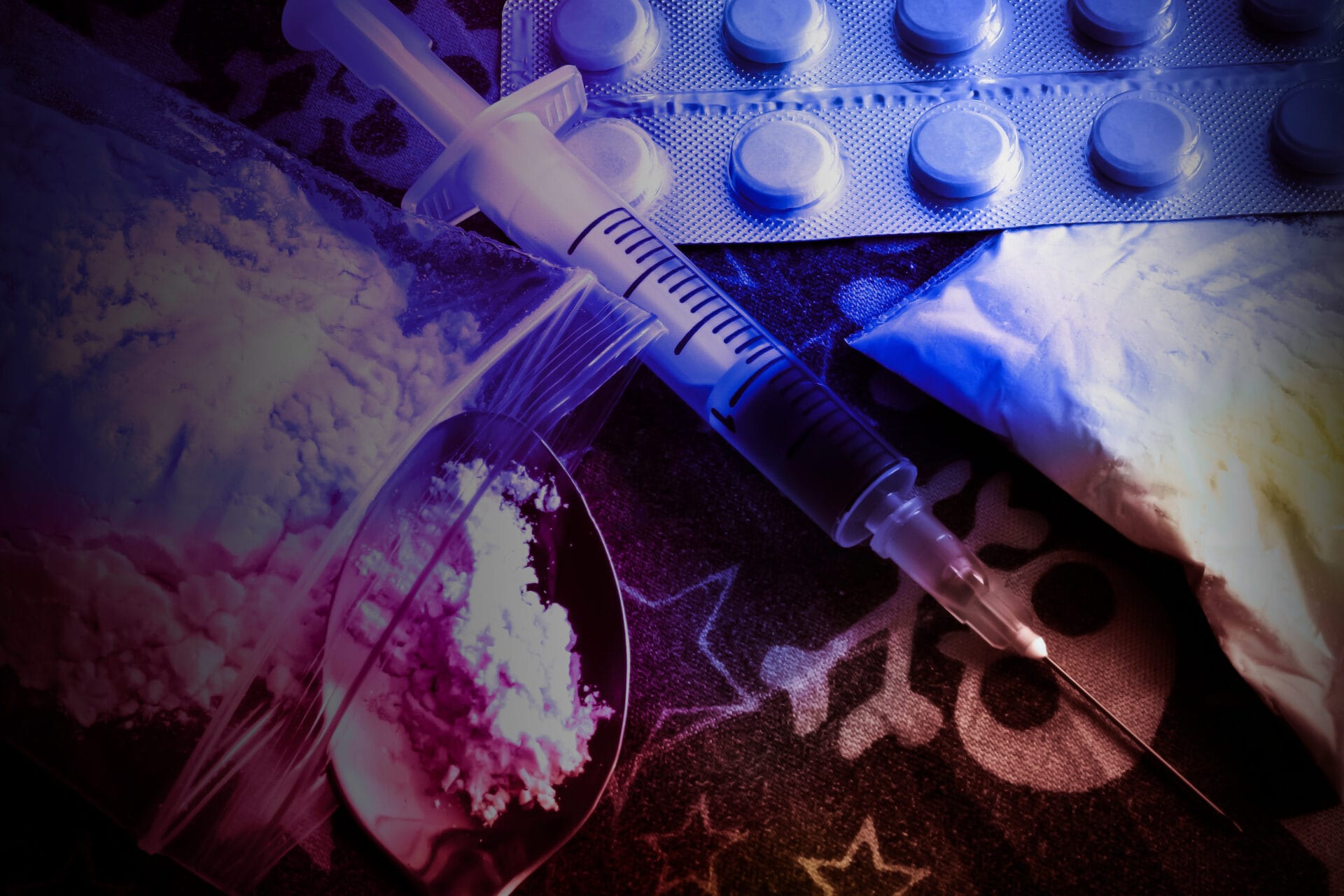 Drugs and a needle on a table